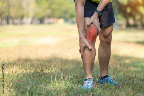 young adult male with muscle pain during running. runner have knee ache due to Runners Knee or Patellofemoral Pain Syndrome, osteoarthritis and Patellar Tendinitis. Sports injuries and medical concept