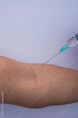 A doctor giving a Covid 19 vaccination to a girl (Close up)