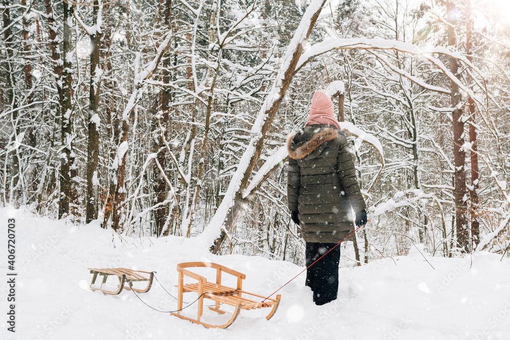 family fun in winter on a sled in the forest family fun in winter on a sled in the forest