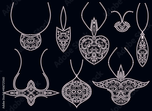 A set of beautiful pendants. White and black design for jewelry. Isolated objects on a black background. Vector clipart