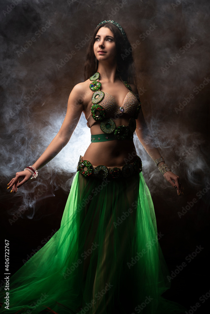Oriental dancer. Belly dance. Smoke. Fairy tale. The brunette.