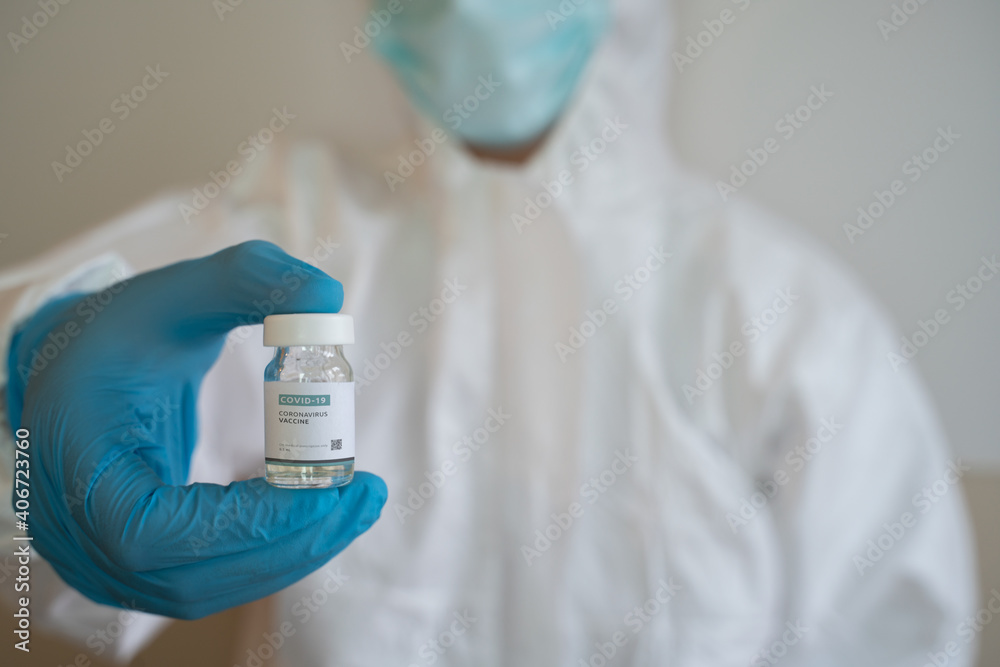 healthcare worker nurse, doctor wearing a medical face mask gloves protective coverall holding hand vaccine bottle tube Coronavirus vaccination choice, acceptance of vaccinate covid-19 concept 2021 healthcare worker nurse, doctor wearing a medical face mask gloves protective coverall holding hand vaccine bottle tube Coronavirus vaccination choice, acceptance of vaccinate covid-19 concept 2021