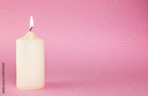 white candle on the pink background