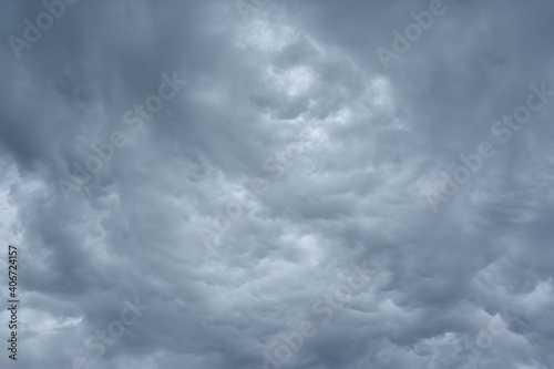 Blue and dark grey heavy clouds in the sky before a thunderstorm. Dramatic backdrop or wallpaper. Natural dangerous menacing background. Ahead of a storm or cataclysm