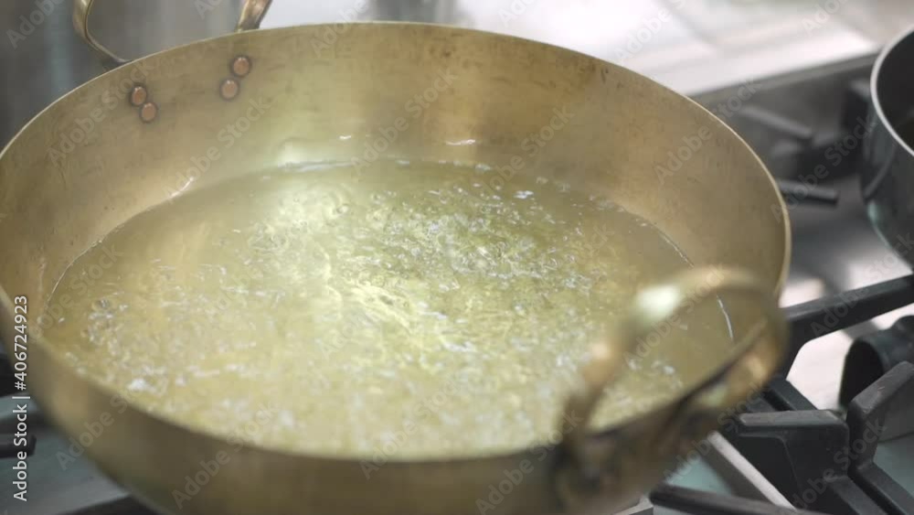 Boiling water in a Brass pan.Thai cuisine Boiling water in a Brass pan.Thai cuisine