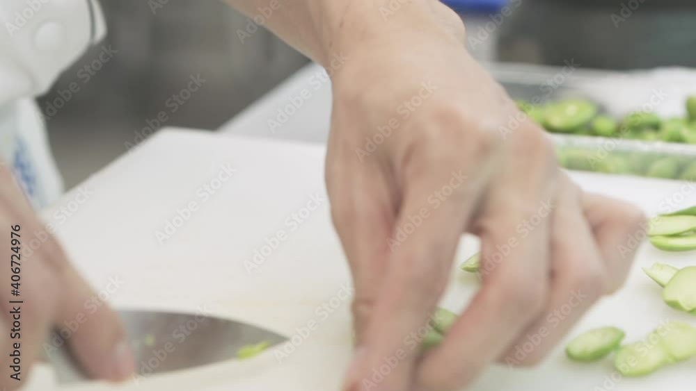 The woman cuts bitters on a wooden board. The woman cuts bitters on a wooden board.