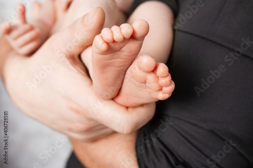 Baby feet in father hands. Dad and his child. Happy family concept. Beautiful conceptual image of Parenthood