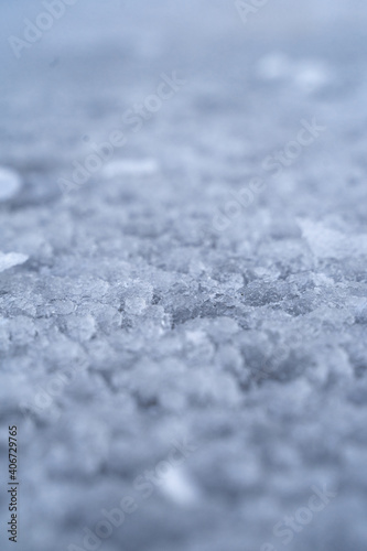 The icy texture on the frozen river. Crystal abstraction for the background. Macro ice surface shoot. 