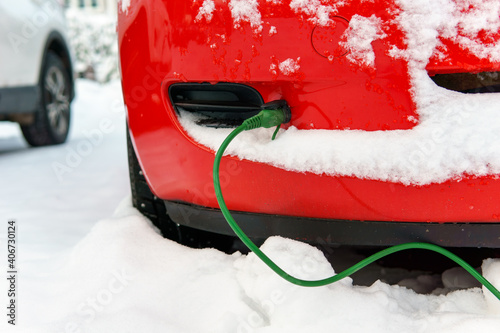 Block heater cable plugged into a car on a cold winter day to warm engine.