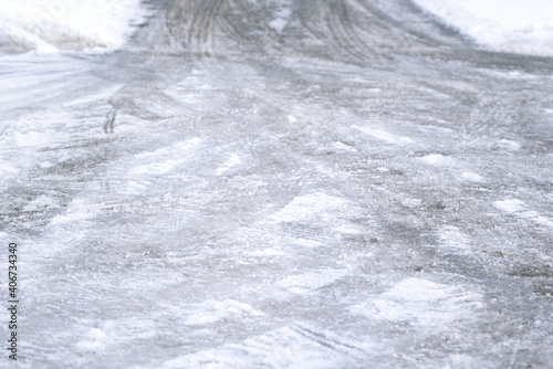 Background and detail of a smooth and icy road in winter © leopictures