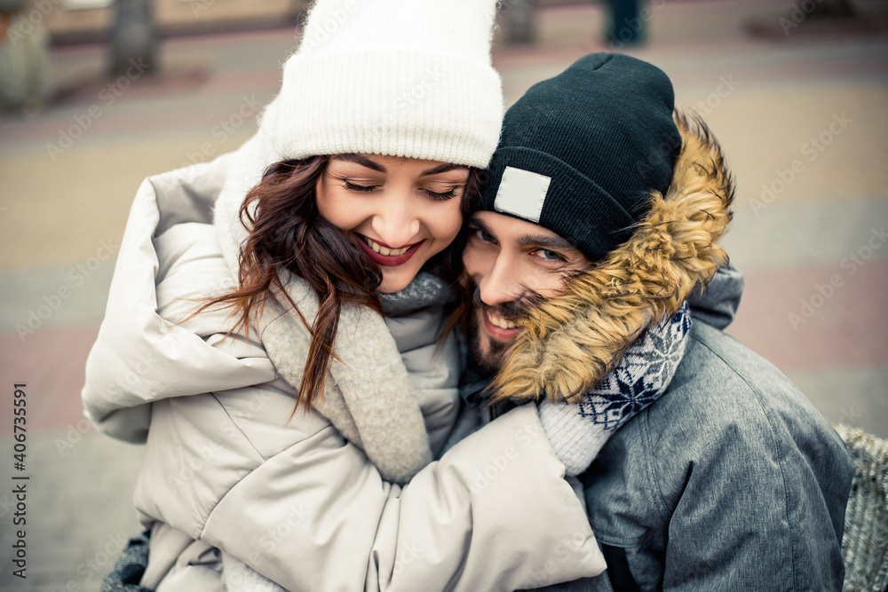 Young lovely couple bride groom newlyweds sitting street kissing hugging, spending time together, smiling happy joke. New Year Christmas decorations, Valentines Day concept. Young lovely couple bride groom newlyweds sitting street kissing hugging, spending time together, smiling happy joke. New Year Christmas decorations, Valentines Day concept.