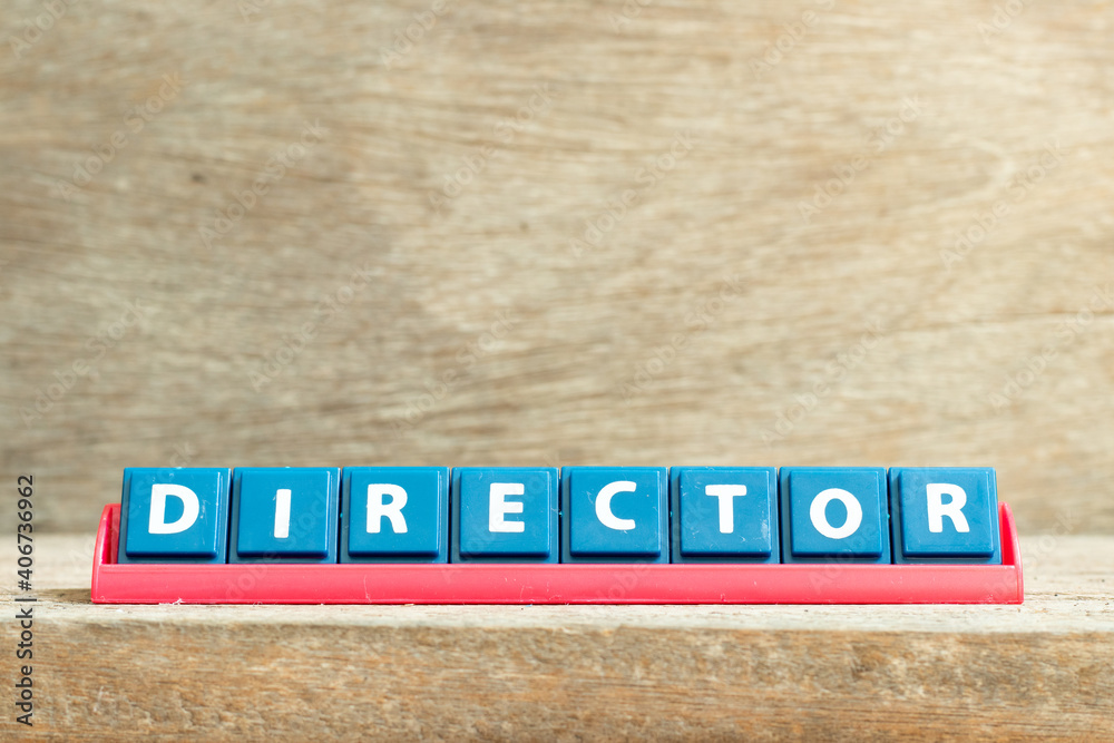 Tile letter on red rack in word director on wood background Tile letter on red rack in word director on wood background