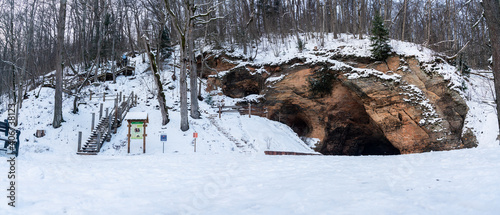 Gutmanis cave, the widest and highest cave in the Baltics, during snowy winter day. Sigulda, Latvia photo