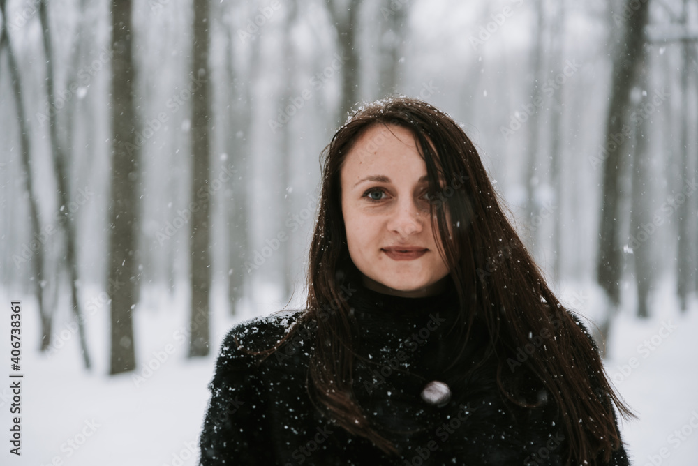Portrait of a woman on the background of a snowy forest Portrait of a woman on the background of a snowy forest