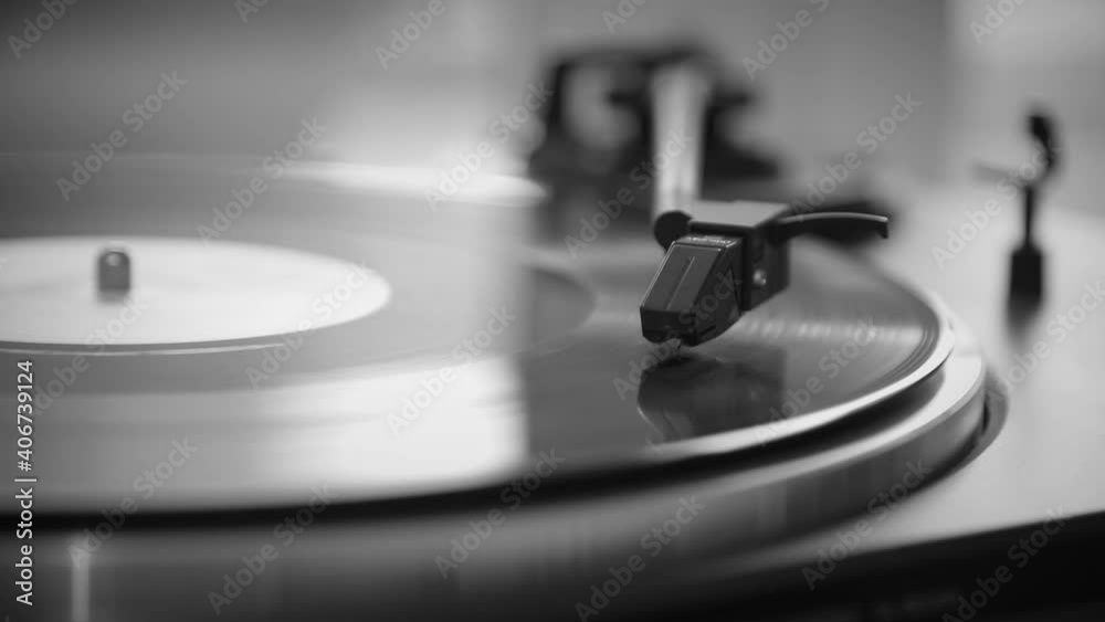 Black and White. The needle goes down on a vintage vinyl record. The vinyl record is spinning. The needle plays on a vintage vinyl record. Old turntable Black and White. The needle goes down on a vintage vinyl record. The vinyl record is spinning. The needle plays on a vintage vinyl record. Old turntable