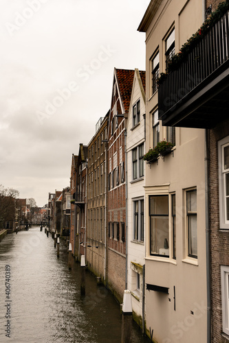 canal lined with houses in the medieval town centre of Dordrecht, the Netherlands © tselykh