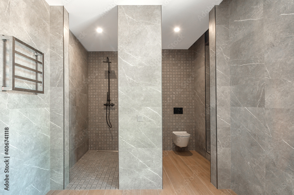 Modern gray shower room. Shower room without tray. Walls tiled with natural material.