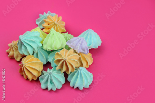 Colored meringues on a pink background. Desert, sweets, cake shop concept