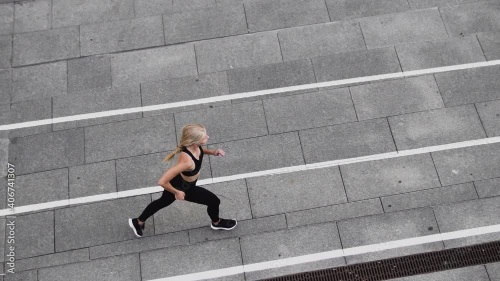 Female runner exercising outdoors, physical activity, urban workout, warmup Female runner exercising outdoors, physical activity, urban workout, warmup