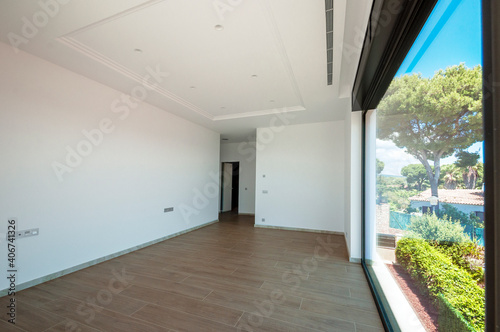 Empty room with large panoramic windows overlooking the sea. Room after major renovation. © steftach