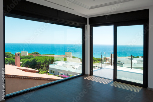 Empty room with large panoramic windows overlooking the sea. Room after major renovation.  © steftach