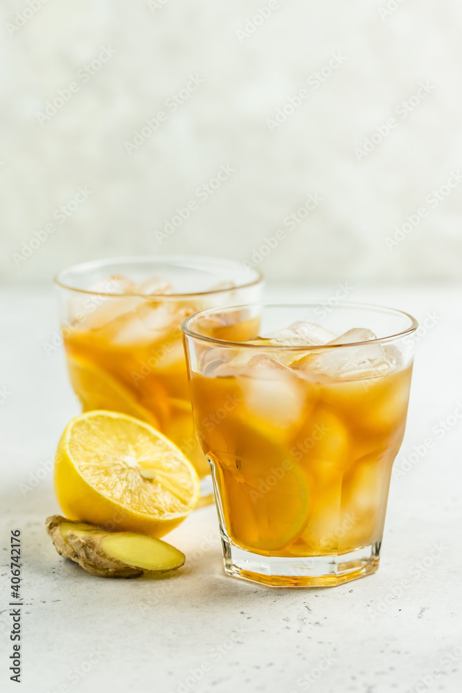 Summer party cocktail, iced lemon ginger tea in glasses. Space for text. Summer party cocktail, iced lemon ginger tea in glasses. Space for text.