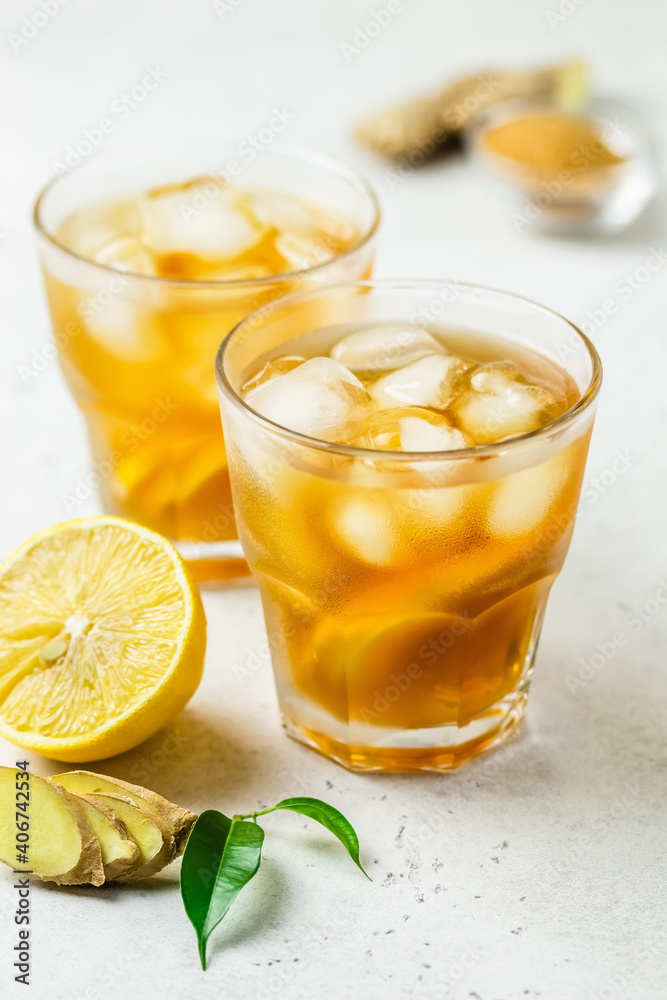 Iced tea with lemon, ginger and brown sugar in glasses. Space for text. Iced tea with lemon, ginger and brown sugar in glasses. Space for text.