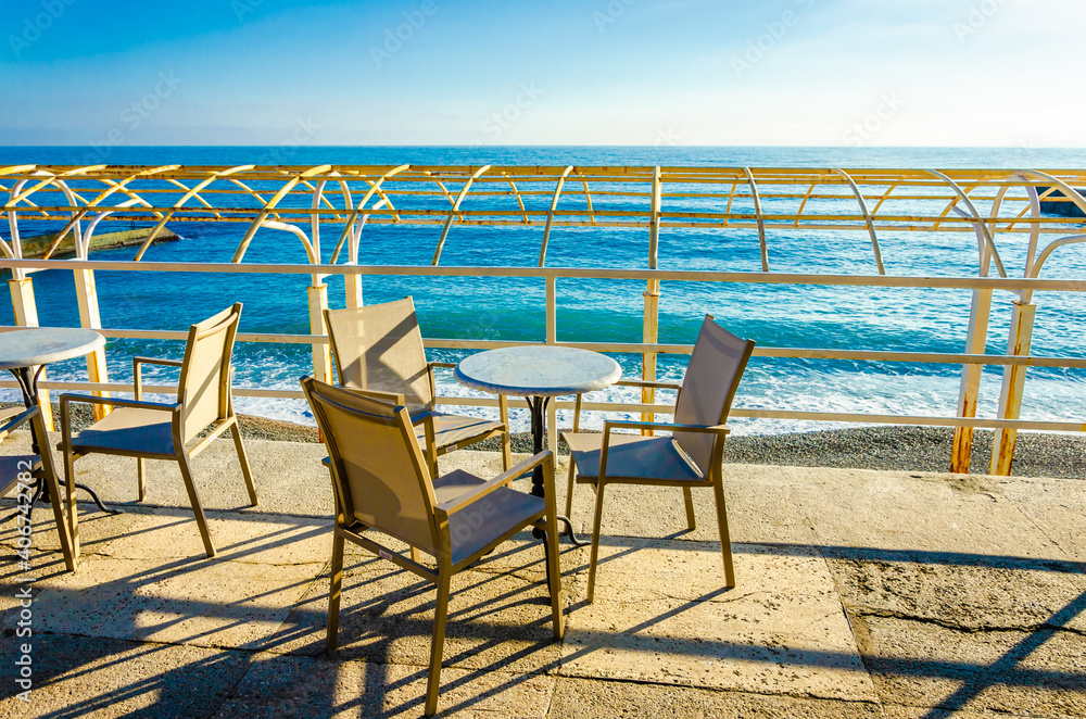 Table with chairs on the beach in a cafe.