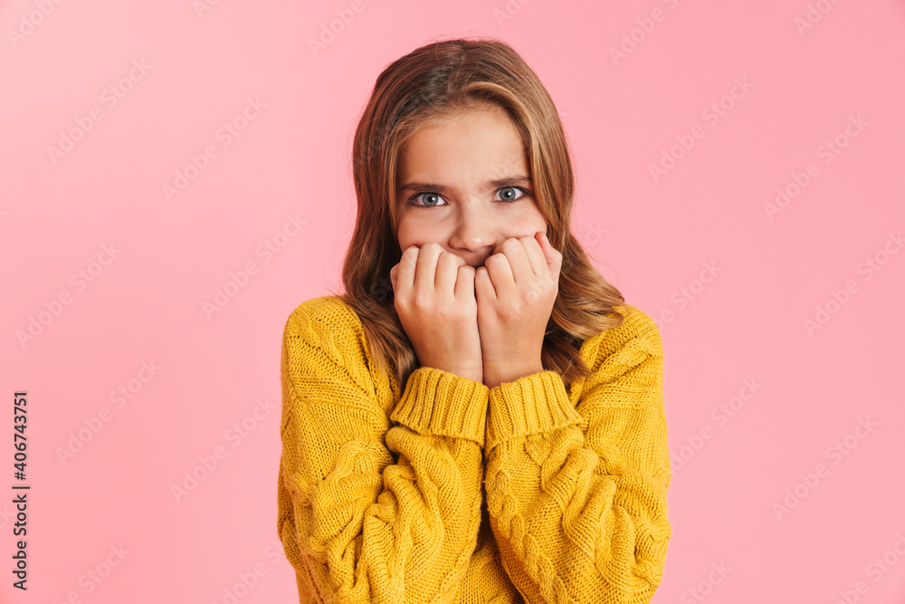 Scared beautiful blonde girl covering her face and looking at camera Scared beautiful blonde girl covering her face and looking at camera