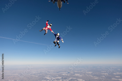 Skydiving. Funny jump. A man and a woman are having fun in the sky.