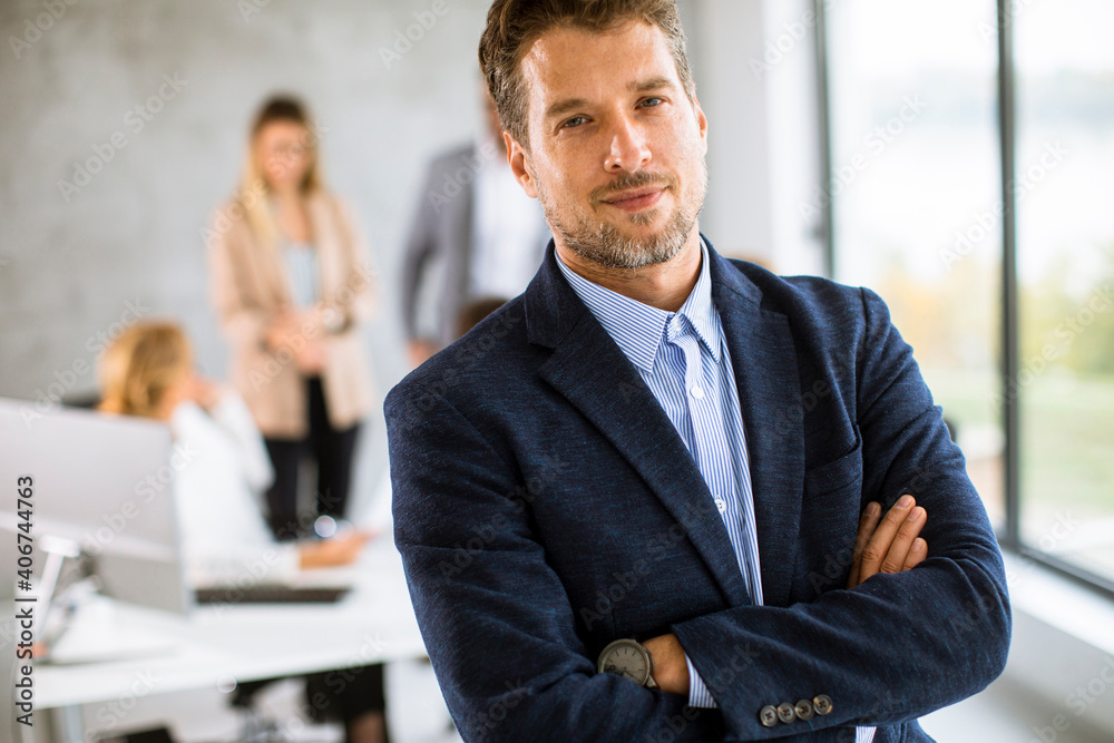 Fototapeta premium Handsome young business man standing confident in the office
