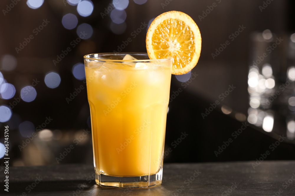 Delicious cocktail with orange on bar counter Delicious cocktail with orange on bar counter