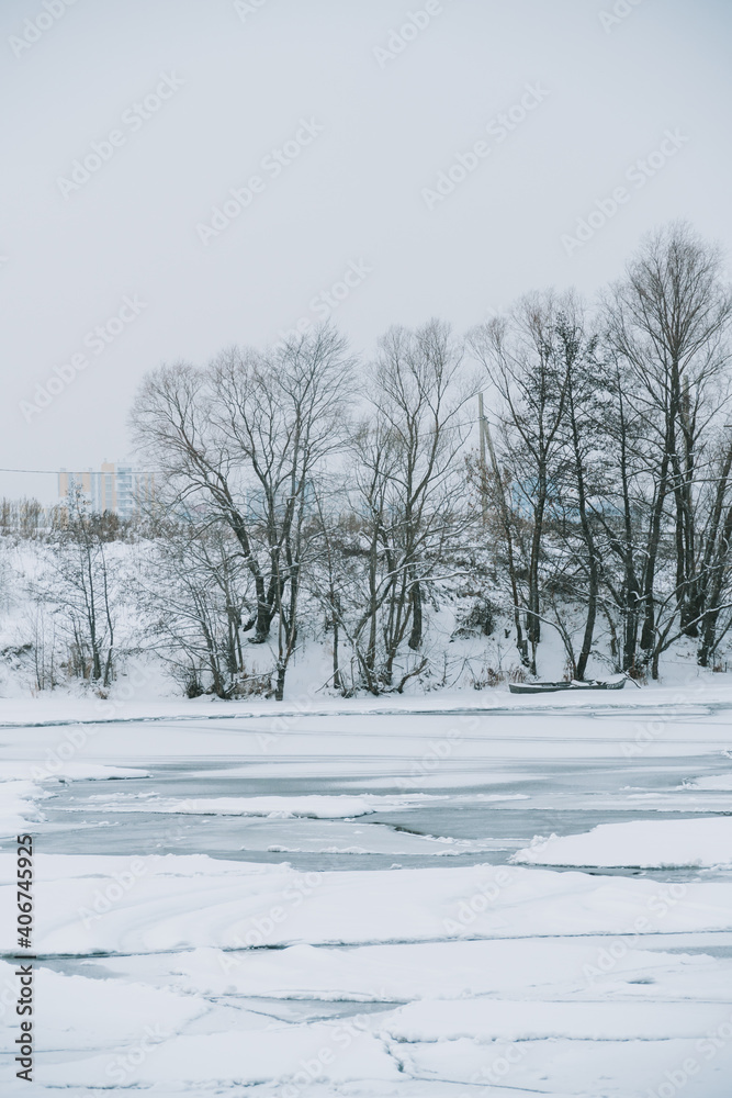 Fototapeta premium Winter frosty landscape of the river with broken ice