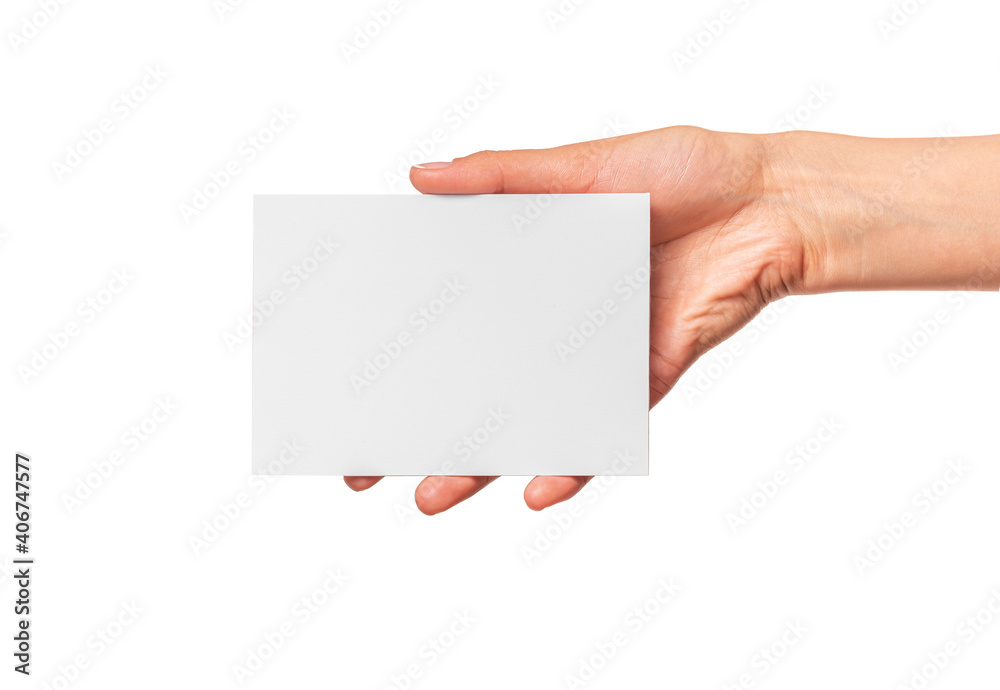 Female hand holds a white card isolated on a white background. Female hand holds a white card isolated on a white background.