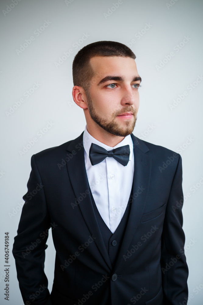 Stylish successful male businessman in a black jacket and with a bow tie Stylish successful male businessman in a black jacket and with a bow tie