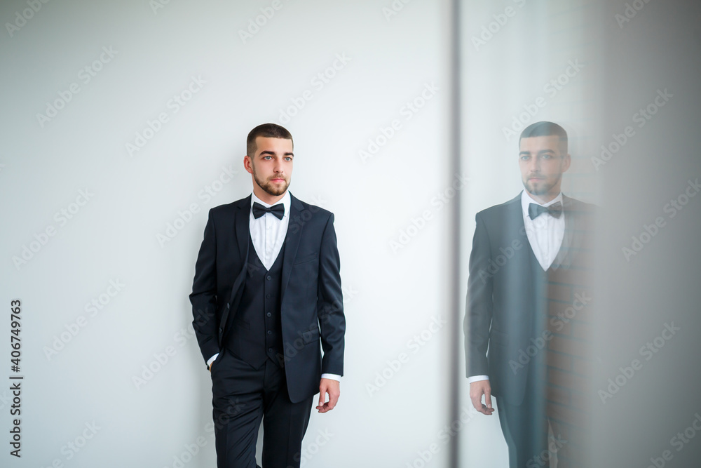 Stylish successful male businessman in a black jacket and with a bow tie Stylish successful male businessman in a black jacket and with a bow tie