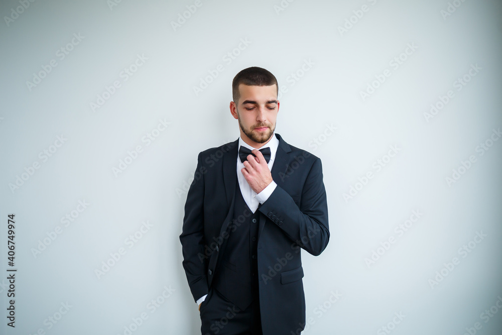 Stylish successful male businessman in a black jacket and with a bow tie Stylish successful male businessman in a black jacket and with a bow tie