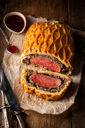 Perfect homemade juicy Beef Wellington, tenderloin dish on rustic wooden table