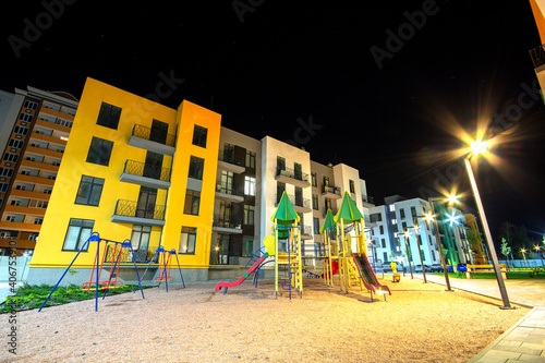 Wallpaper Mural Children playground at night in residential district yard between apartment buildings. Torontodigital.ca