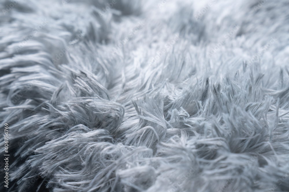 Close up white shaggy artificial fur texture or carpet for background. Close up white shaggy artificial fur texture or carpet for background.