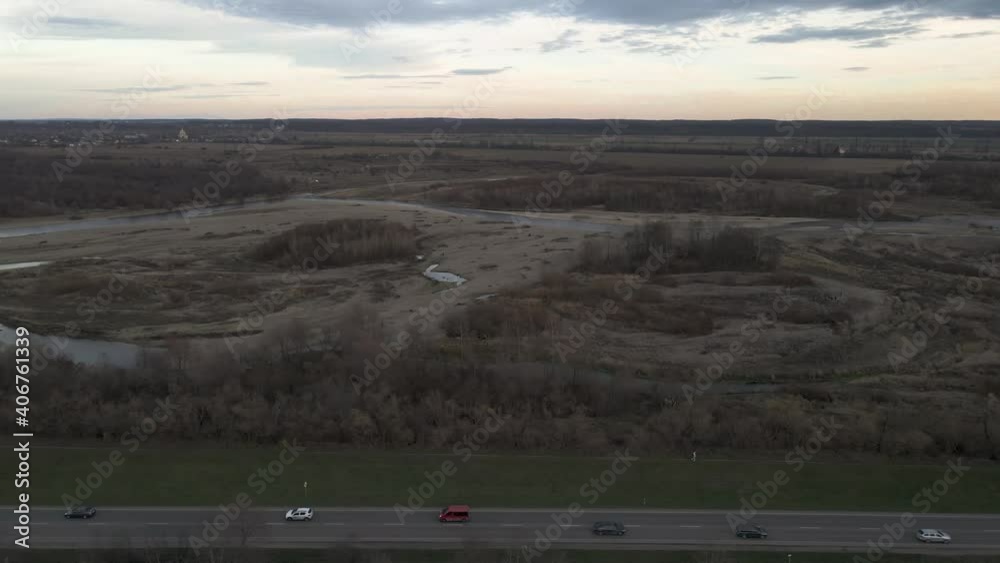Aerial shot of traffic driving on road next to dried out river outside Lviv. Ukraine. Aerial shot of traffic driving on road next to dried out river outside Lviv. Ukraine.