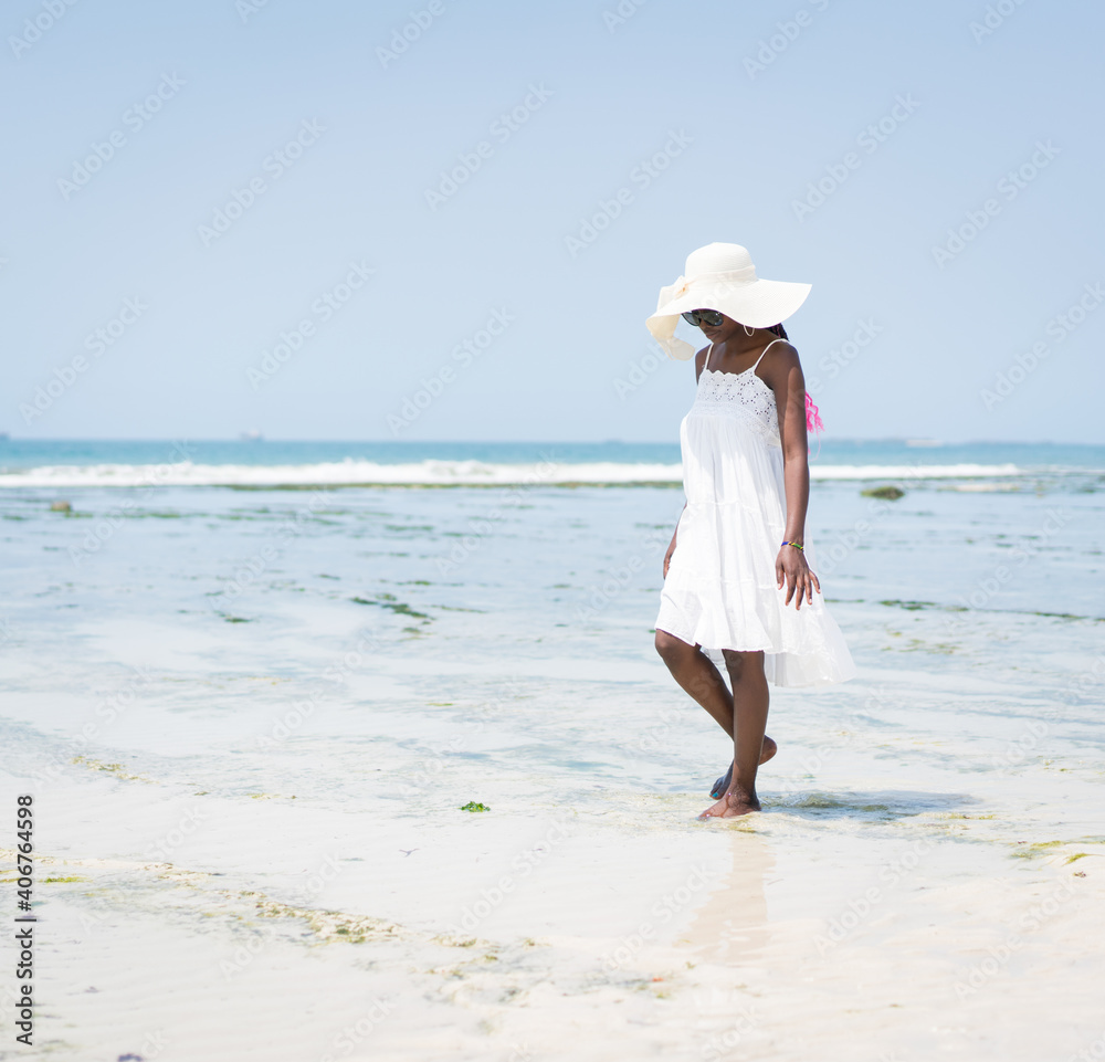 Beautiful young black African American woman on the tropical beach