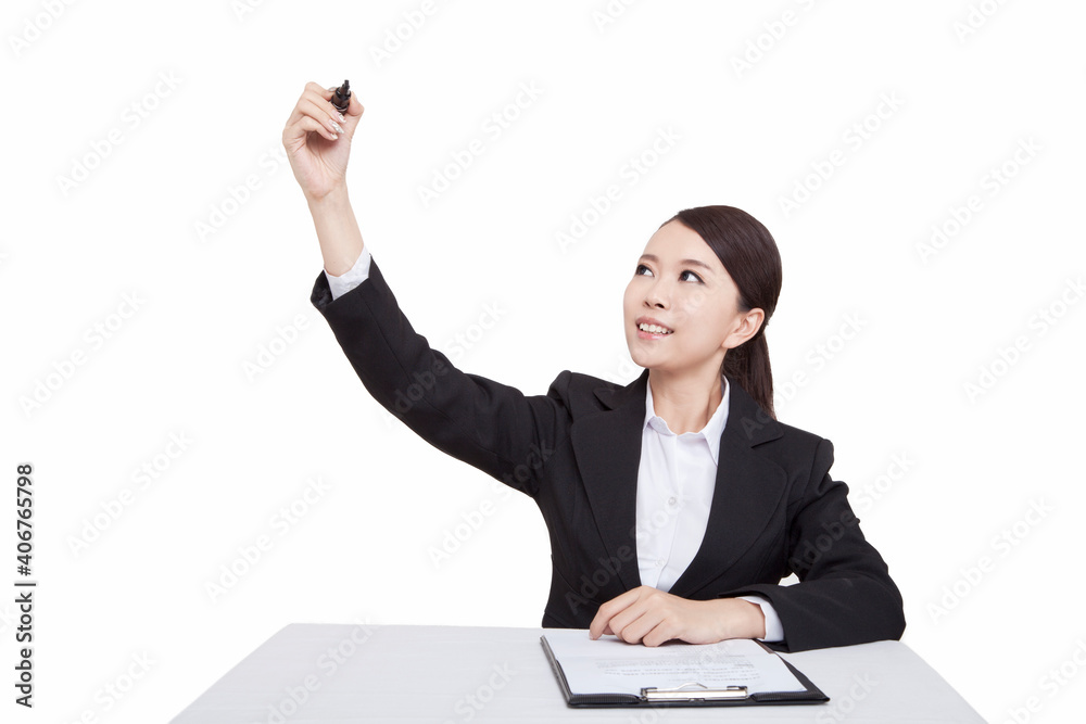 Portrait of young businesswoman sitting at desk holding pen Portrait of young businesswoman sitting at desk holding pen