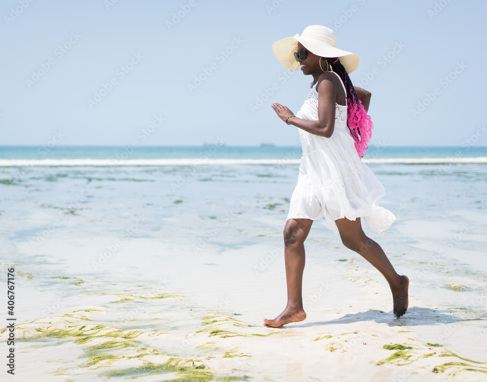 Beautiful young black African American woman on the tropical beach Beautiful young black African American woman on the tropical beach