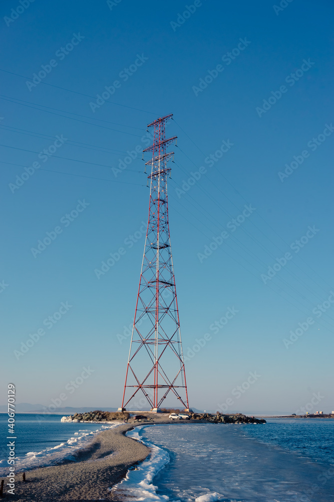 High-voltage tower against the blue sky
