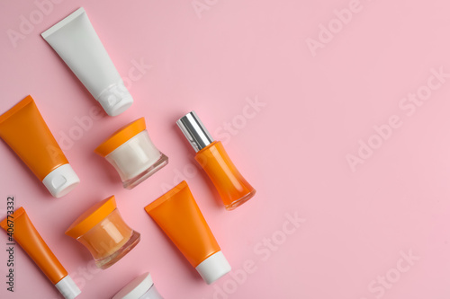 Set of luxury cosmetic products on pink background, flat lay. Space for text