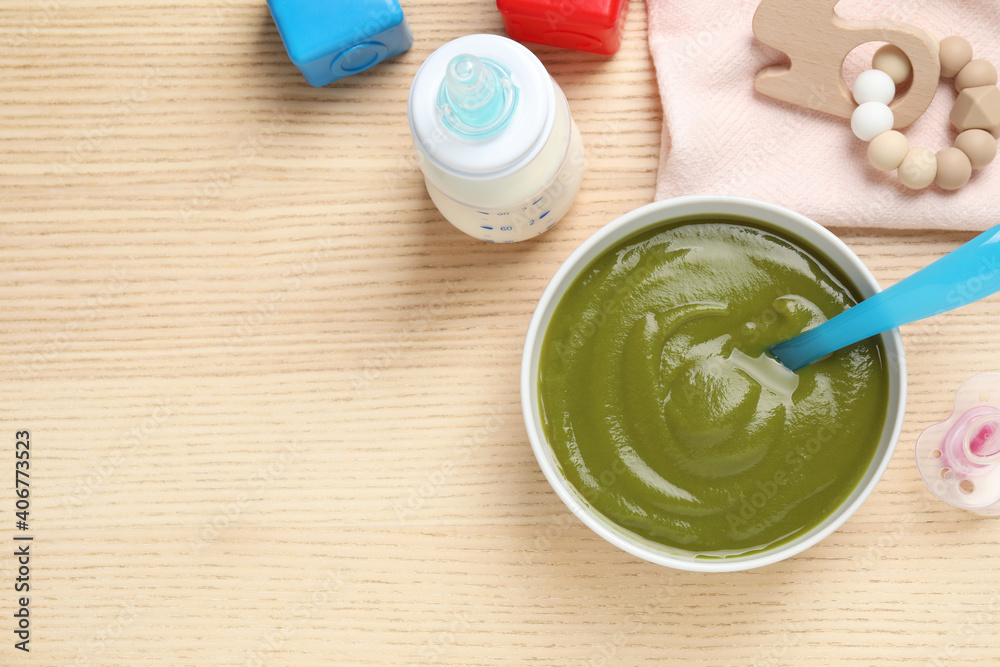 Flat lay composition with healthy baby food on wooden table, space for text Flat lay composition with healthy baby food on wooden table, space for text