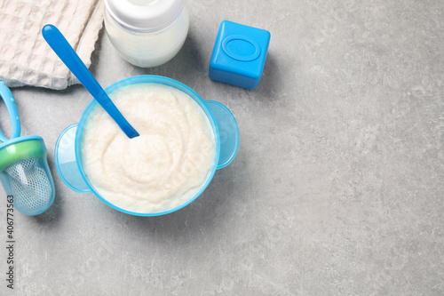 Flat lay composition with healthy baby food on grey table  space for text