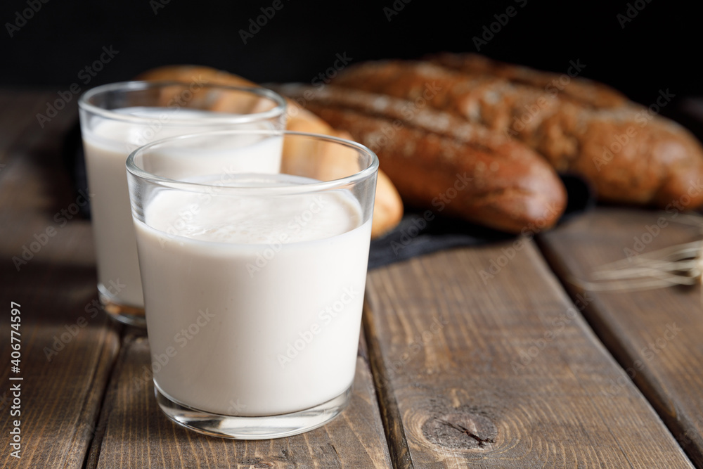 Kefir - trendy healthy food available providing powerful probiotics. Probiotic cold fermented dairy drink on wooden background. Rustic style. Probiotic food concept. Copy space, close up Kefir - trendy healthy food available providing powerful probiotics. Probiotic cold fermented dairy drink on wooden background. Rustic style. Probiotic food concept. Copy space, close up