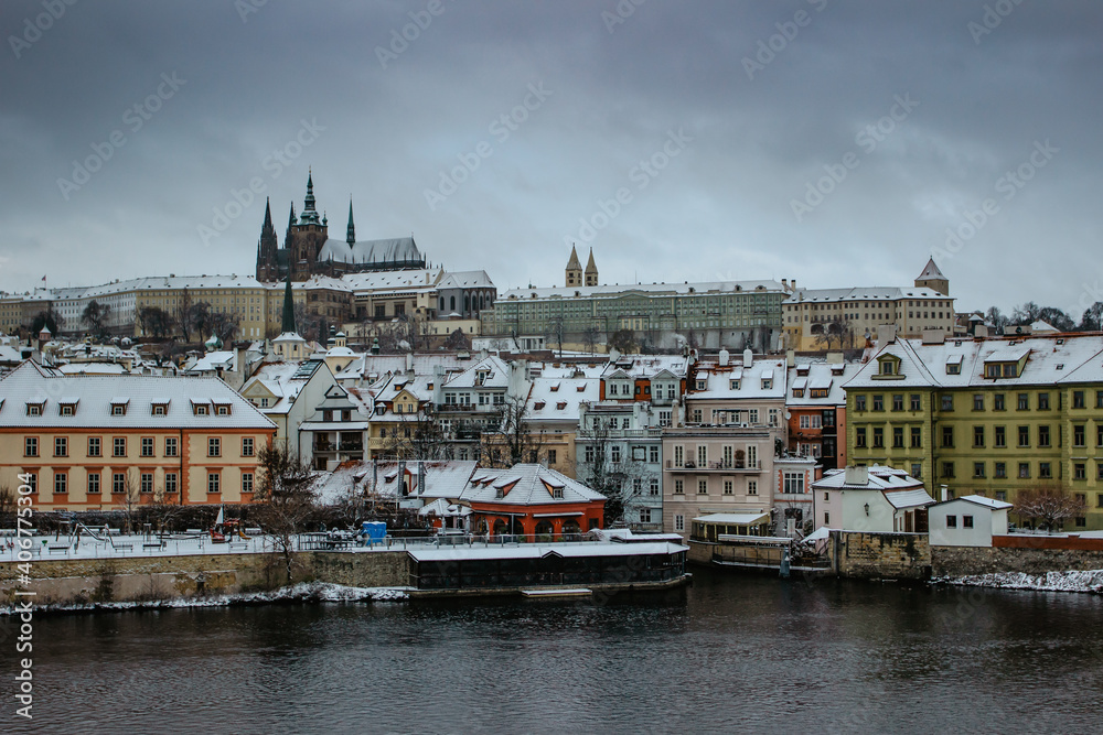 Postcard view of Prague Castle from Charles Bridge, Czech republic.Famous tourist destination.Prague winter panorama.Snowy day in the city.Amazing European cityscape cold weather.Romantic atmosphere.